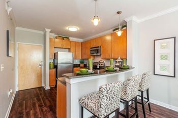 A kitchen with a refrigerator, microwave, and oven